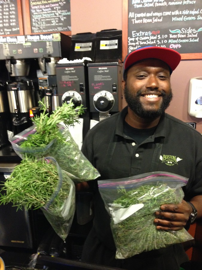 Happy Boston Common Coffee Co employee accepting their delivery of Greenway herbs!