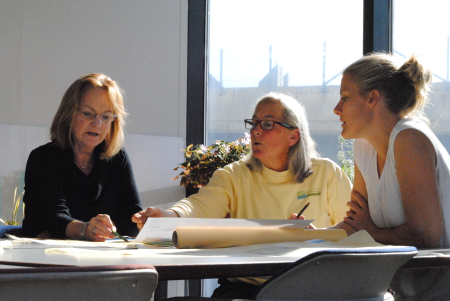 From Left to Right: Linda, Darrah, and Hannah working on plans for the boxwood beds