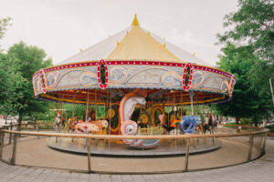 A brightly colored carousel featuring a variety of animals including fish, lobsters, and a whale.